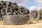 A stack of tires on an old garbage dump. Old worn out tires pile