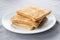 Stack of toasted bread on white dish