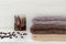 Stack of towels, candy, coffee beans on white wooden background