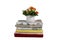 A stack of towels of different colors and a bouquet of flowers in a vase isolated on a white background