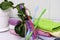 A stack of towels pieces of soap toothbrushes in a glass and a houseplant on the bathroom table