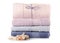 A stack of towels pink blue spa sea seashell stones