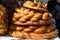 Stack of traditional colaci or baked buns, home made specialty of bread displayed for sale at a street food market in Bucharest, R