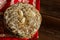 Stack of Traditional German Christmas Gingerbread Cookies Glazed Lebkuchen with Almonds. Festive Red Napkin Wood Table.