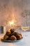 A stack of traditional oliebollen (Dutch dough fritters) with a glass of champagne on white background with sparklers