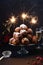 A stack of traditonal Dutch oliebollen (translation: deep fried dough balls) with sparkles and champagne