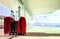 stack of traveling luggage in airport terminal building with passenger plane flying background