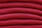 Stack of trend Biking Red sweaters close-up, texture, background