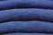 Stack of trend Sargasso Sea woolen sweaters close-up, texture, background