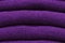 Stack of trend Ultra Violet woolen sweaters close-up, texture, background