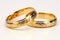 stack of two golden wedding rings against a white background