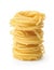 Stack of uncooked tagliolini pasta nest