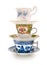 Stack of a variety of teacups on a completely white background. Contains clipping path