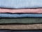 Stack of various jeans and corduroy slacks