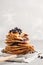 Stack vegan blueberry pancakes with peanut butter and syrup.