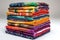 stack of vibrant quilts folded neatly