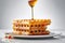 a stack of waffles with syrup on a plate. Generative AI