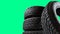 Stack of wheel new black tyres for winter car driving isolated on colored background