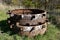 Stack of wheels for old tractors left on the grass