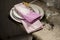 Stack of White Dinner Plates and Purple Cloth Napkins