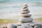 Stack of white pebbles stone against sea background for spa, balance, meditation and zen theme.