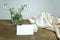 Stack of whites business card on wooden table, snowdrop flowers, silk drapery, business concept, invitation, postcard, blank