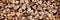 Stack of wood logs, wood abstract panoramic fall and winter background