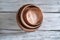 Stack of wooden dishes of different diameters from elm on wooden background