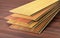 Stack of wooden laminate parquet on a wooden blur background.