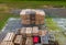 Stack of wooden pallets aerial view. Outdoor pallet storage area under the roof next to the chicken farm. Piles of Euro-type cargo