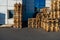 A stack of wooden pallets in an internal warehouse. An outdoor pallet storage area under the roof next to the store. Piles of Euro