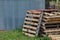 Stack of wooden pallets next to the corrugated iron tank on a country property