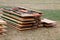 Stack of wooden party tables and benches are lying in the garden after a party