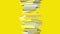 Stack of yellow books isolated on yellow background.