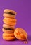 Stack of yellow  macaroons on a lilac background, beige