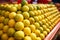 A stack of yellow ripe and sweet lines on the whole screen on the market. Lime and lemons background. Fresh organic lemons and