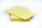 Stack of yellow, ruled notepads with top one offset