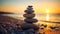 Stack of zen stones on pebble beach at sunset