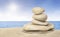 Stack of zen stones on sunny sand beach