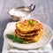 Stack of zucchini and feta fritters on plate