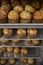 Stacked baking trays of fresh muffins at a bakery, close up