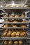 Stacked baking trays of freshly baked muffins at a bakery