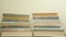 Stacked books on dark wooden background. Reading concept. Time lapse. Accelerated frame-by-frame shooting