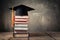 Stacked books towering over graduation cap, symbolizing academic achievement and ambition