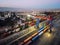 Stacked cargo containers and overhead gantry crane. Aerial view. Mersin, Turkey - December 2020