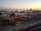 Stacked cargo containers and overhead gantry crane. Aerial view. Mersin, Turkey - December 2020