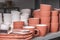 Stacked ceramic bowls, pots, dishes and mugs, clay handmade products after baking in kilns in the potter`s studio