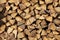 Stacked chopped beech tree firewood background texture