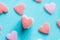 Stacked Colorful Pastel Sugar Candy Sprnikles on Light Blue Background. Valentine Mother`s Day Kid`s Charity Concept