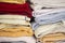 Stacked colorful towels inside a closet.